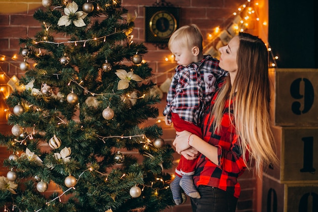 Mutter mit dem Sohn, der Weihnachtsbaum verziert