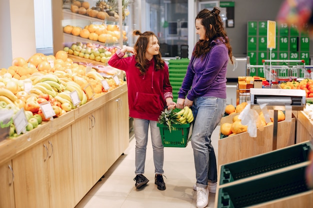 Mutter mit einer tochter in einem supermarkt