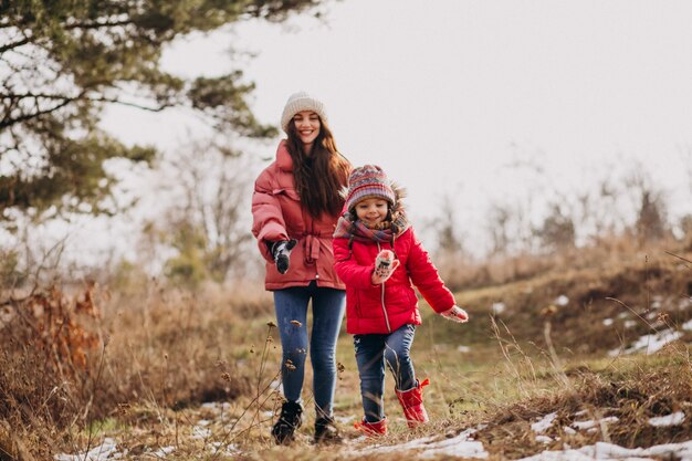 Mutter mit kleiner tochter in einem winterwald