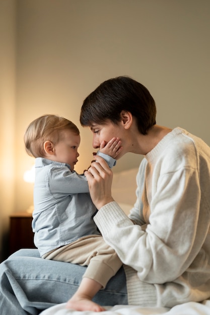 Mutter mit mittlerem Schuss, die Baby hält