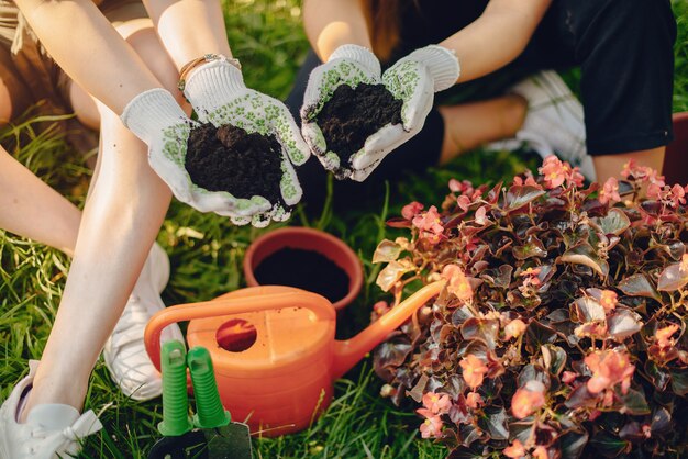 Mutter mit Tochter arbeitet in einem Garten in der Nähe des Hauses