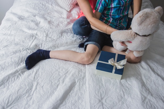 Mutter und Sohn mit Geschenk und Teddybär