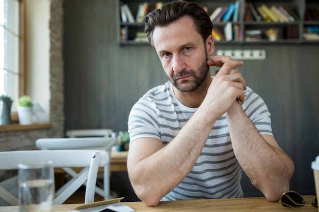 Kostenloses Foto nachdenklicher mann im café sitzen