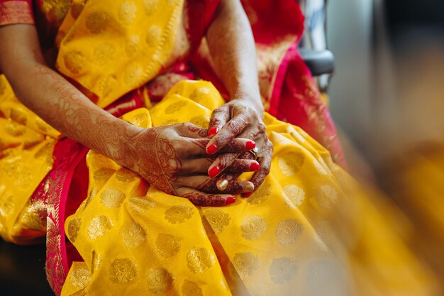Nahaufnahme der Hände der hindischen Braut bedeckt mit Hennastrauchtätowierungen