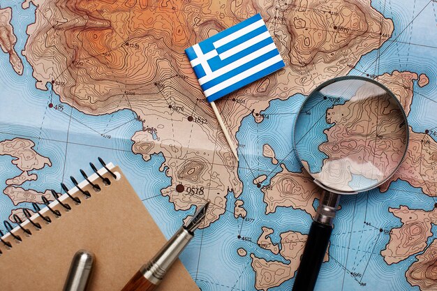 Nahaufnahme der kleinen griechischen Flagge über der Karte