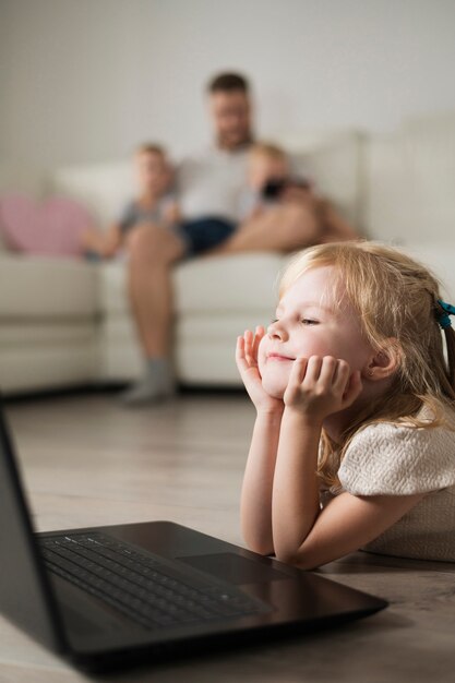 Nahaufnahme des kleinen Mädchens beim Schauen auf Laptop