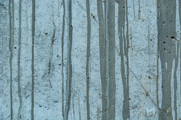 Nahaufnahme einer verwitterten grungy rustikalen Wand mit Farbflecken und altem Zement - perfekte Grunge-Tapete