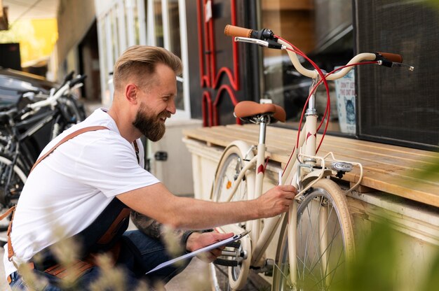 Nahaufnahme eines jungen Mannes, der an einem Fahrrad arbeitet