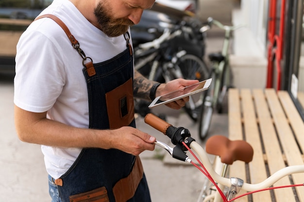 Nahaufnahme eines jungen Mannes, der an einem Fahrrad arbeitet