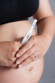 Nahaufnahme schwangerschaftstest in der hand der schwangeren frau