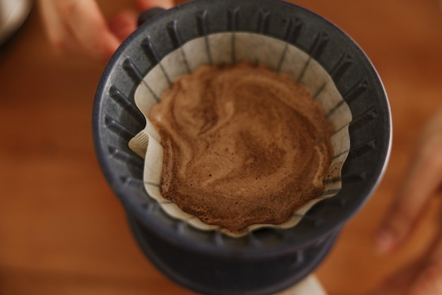 Nahaufnahme von Barista-Händen, die Filterkaffee zubereiten