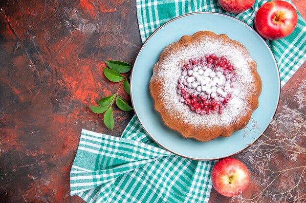 Nahaufnahme von oben ein Kuchen ein appetitlicher Kuchen mit roten Johannisbeeräpfeln auf der weiß-blauen Tischdecke