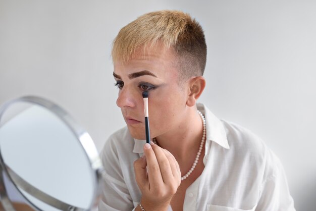 Nahaufnahme von Transgender mit Make-up-Pinsel