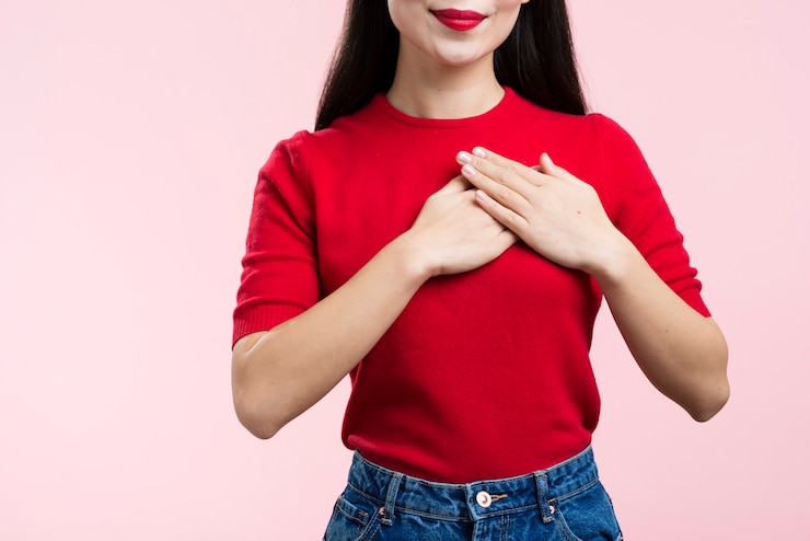 Kostenlose Foto nahaufnahmefrau mit den roten lippen mit der hand auf herzen
