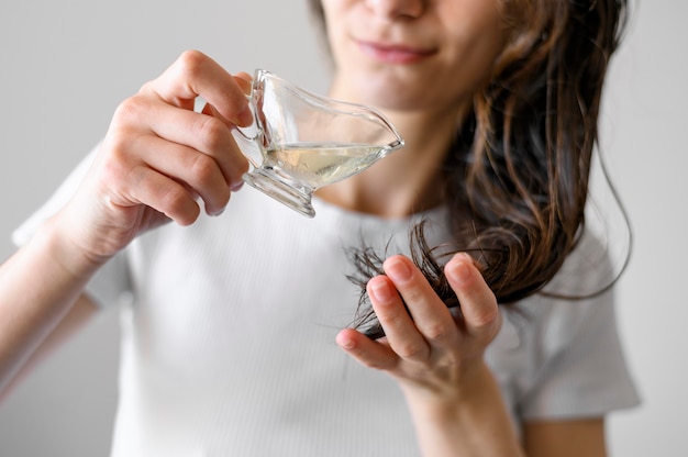 Nahaufnahmefrau mit Serum für Haare