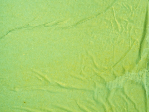 Nahaufnahmegrün zerknitterter Papierhintergrund