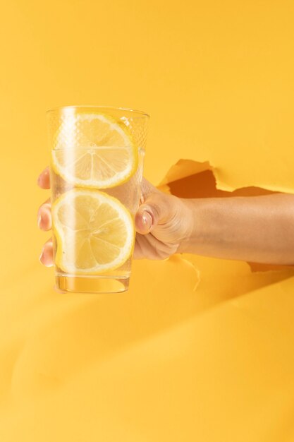 Nahaufnahmehand, die Glas Limonade hält