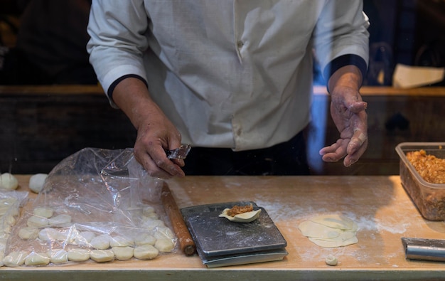 Nahaufnahmekoch, der traditionelles japanisches Essen zubereitet