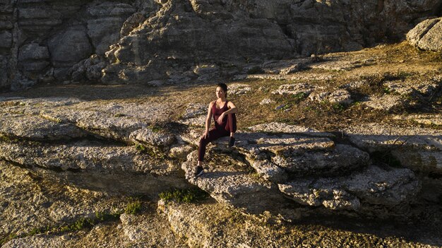 Naturherz mit der jungen Frau, die Yoga tut