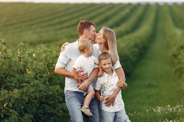 Nette Familie, die in einem Sommerfeld spielt