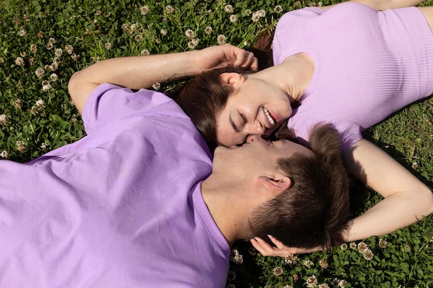 Kostenloses Foto netter freund und freundin, die auf gras liegen