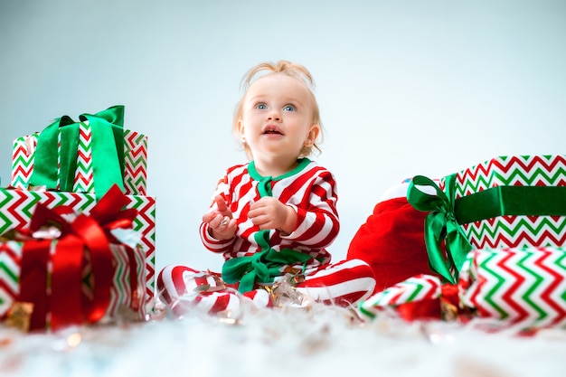 Nettes Baby 1 Jahr alt nahe Weihnachtsmütze, die über Weihnachten aufwirft