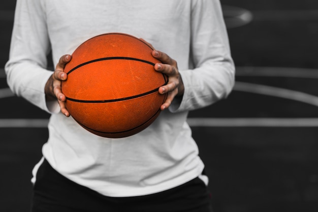 Nicht erkennbarer Spieler, der Basketball hält