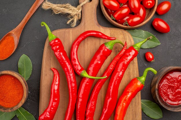 Oben Nahansicht eine Schüssel Kirschtomaten scharfe rote Paprika auf dem Schneidebrett