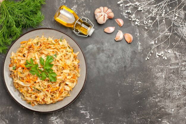 Oben Nahaufnahme Ansicht Kohlplatte der appetitlichen Kohl Knoblauch Kräuter Flasche Öl