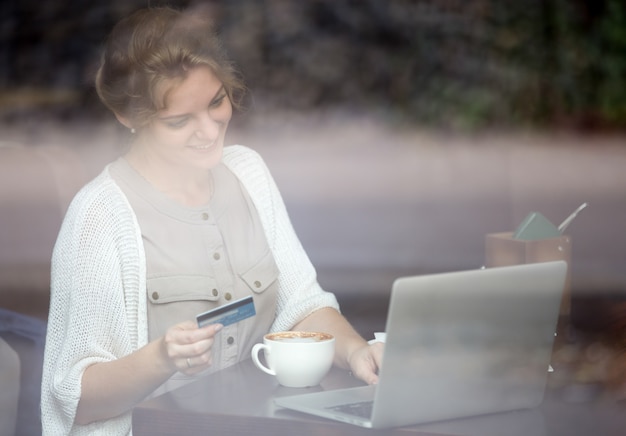 Online Zahlung mit Kreditkarte. Schuss durch Fenster