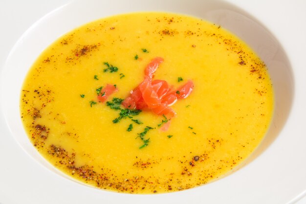 Orange Suppe der Nahaufnahme in einer weißen Platte