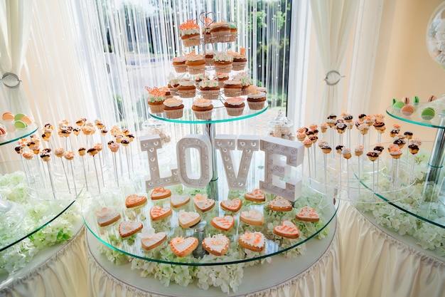Original Cupcakes stehen vor dem Schriftzug LOVE auf dem müden Glas