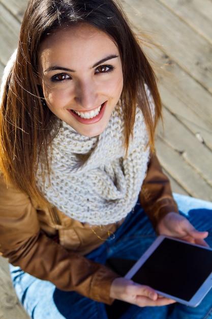 Outdoor Porträt der jungen Frau mit digitalen Tablette