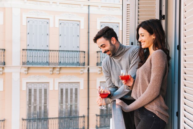 Paare, die auf Balkon trinken