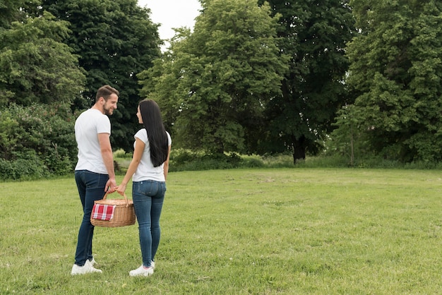 Kostenloses Foto paare, die einen picknickkorb halten