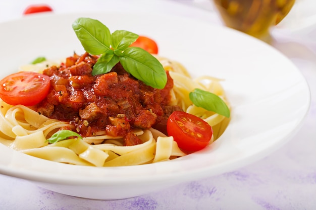 Pasta Fettuccine Bolognese mit Tomatensauce in weißer Schüssel.