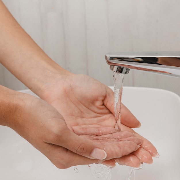 Person, die hände mit wasser wäscht