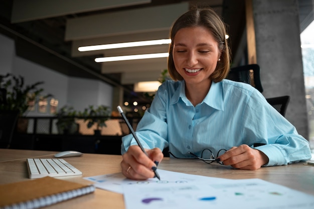 Kostenloses Foto person im büro, die finanzdiagramme analysiert und überprüft