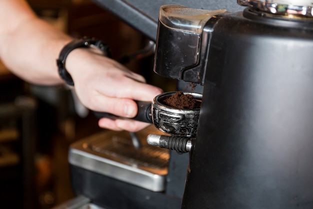 Kostenloses Foto pflanzen sie hand, die portafilter mit kaffee hält