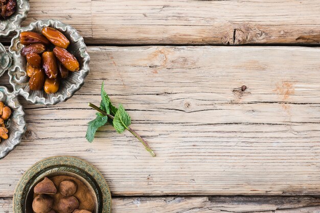 Pflanzenzweig nahe Trockenfrüchten und Bonbon an Bord