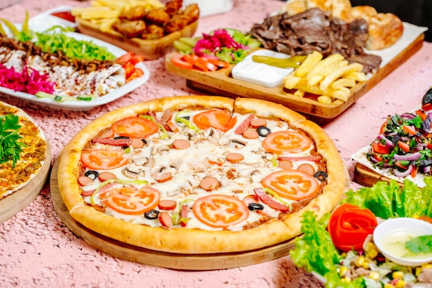 Pizza und anderes Essen auf dem Tisch