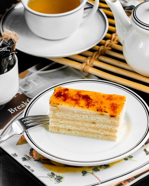 Portionierter Crème-Brûlée-Kuchen aus französischem Gebäck, überzogen mit Sahne