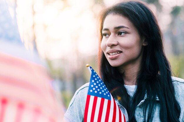 Porträt der ethnischen amerikanischen Frau mit Flagge