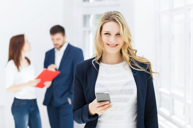 Porträt der Geschäftsfrau, die auf Handy im Büro spricht