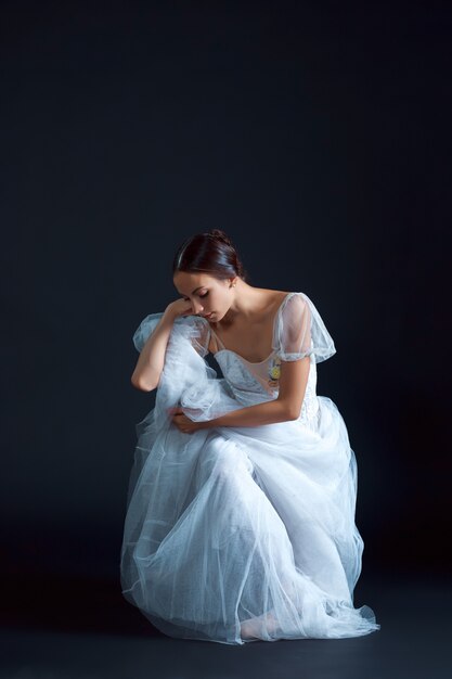 Porträt der klassischen Ballerina im weißen Kleid auf Schwarz