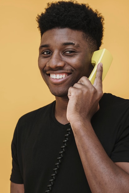 Kostenloses Foto porträt des glücklichen mannes, der am telefon spricht