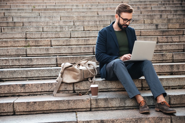 Porträt des jungen Mannes mit Laptop-Computer