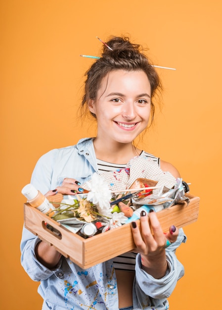 Kostenloses Foto porträt des weiblichen künstlers mit holzkiste