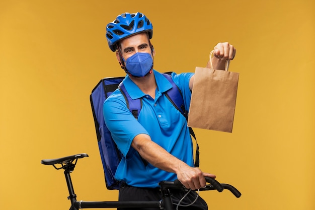 Kostenloses Foto porträt des zustellers, der paket austeilt