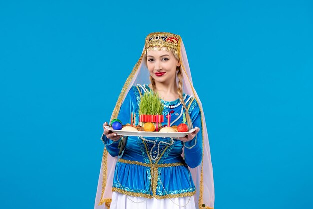 Porträt einer aserbaidschanischen Frau in traditioneller Kleidung mit Novruz Xonca Studio erschossen blauem Hintergrund Tänzer ethnischen Frühling